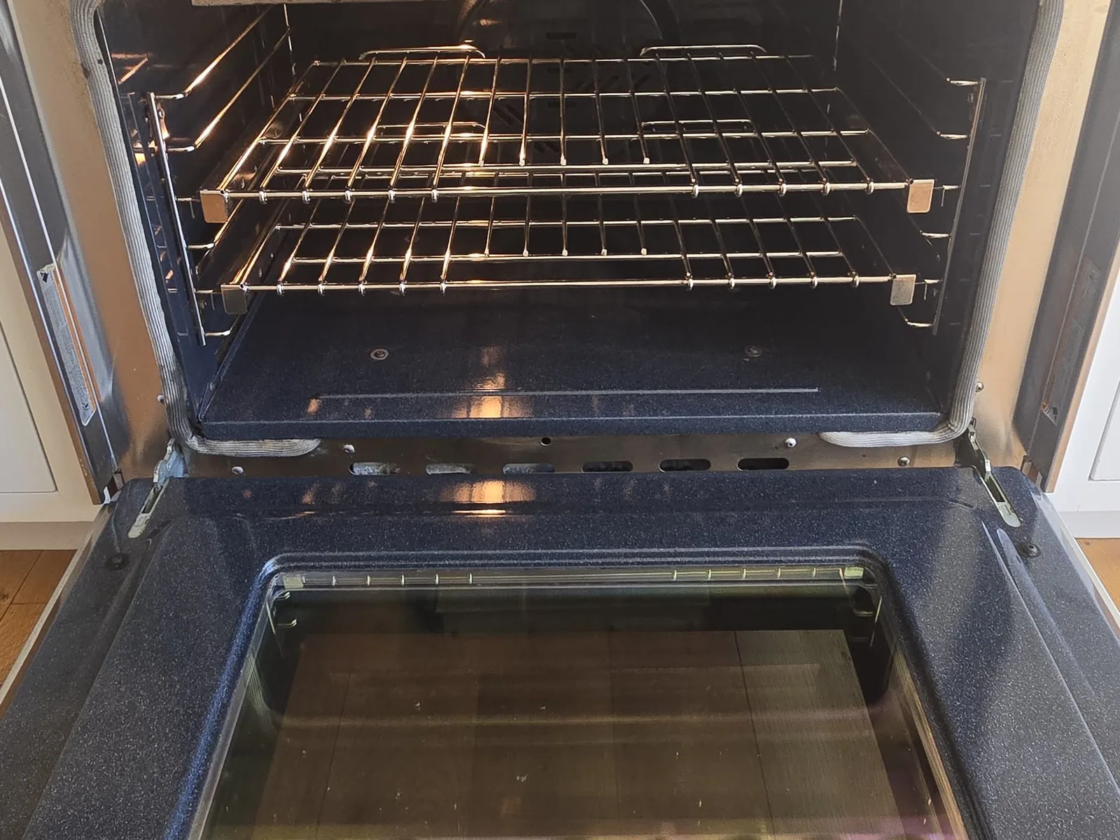 Oven interior after a deep clean, racks and walls clear of grease