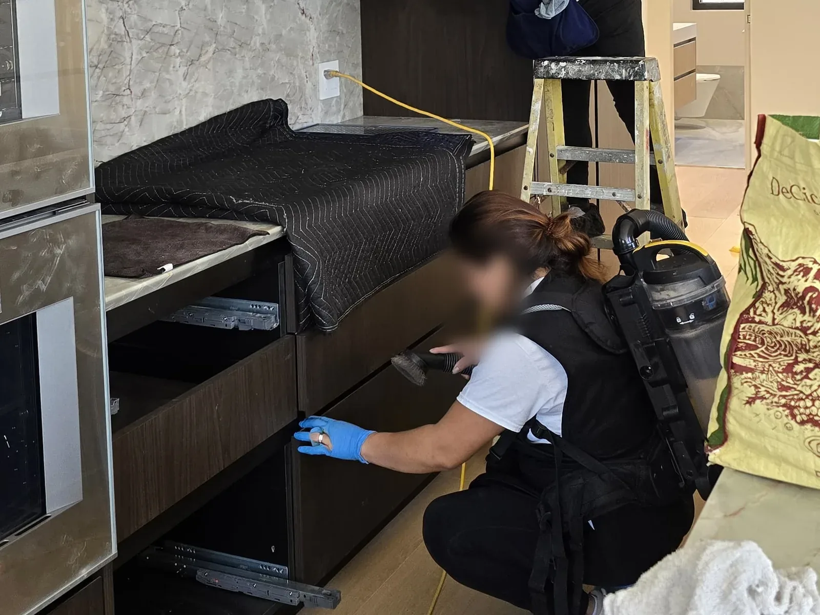Dmax Glow cleaner detailing the inside of a kitchen cabinet